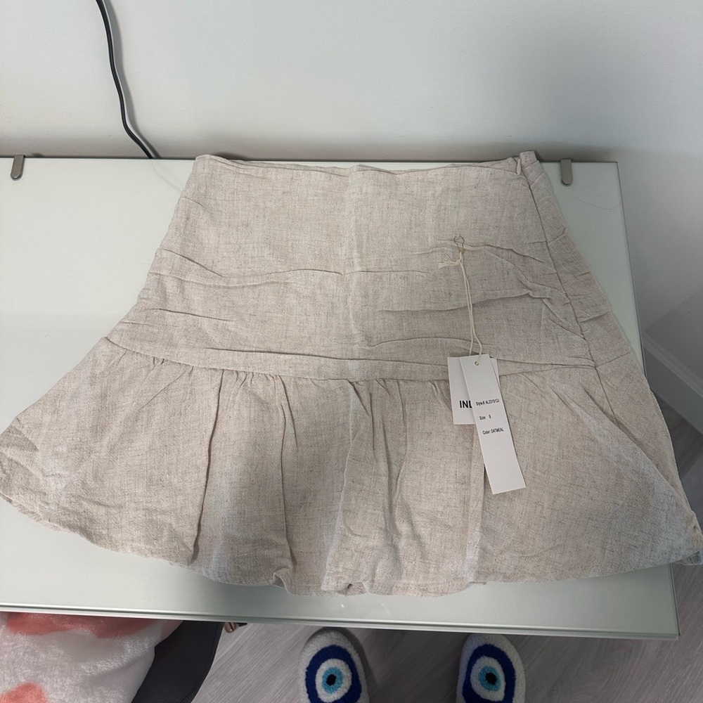 Size SMALL linen skirt with shorts underneath.. COLOR: oatmeal